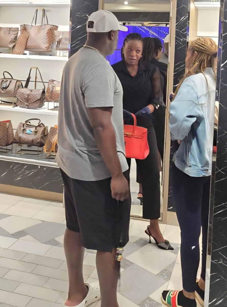 Guests browsing handbags inside a luxury retail boutique
