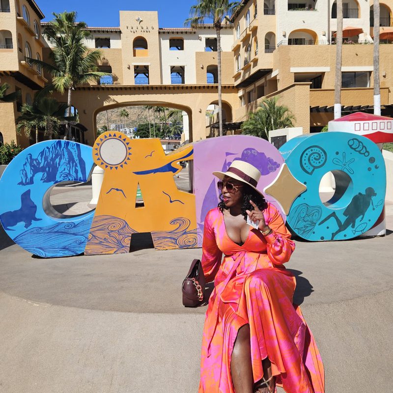 Hayley Molefe beside a colourful mural in Cabo San Lucas