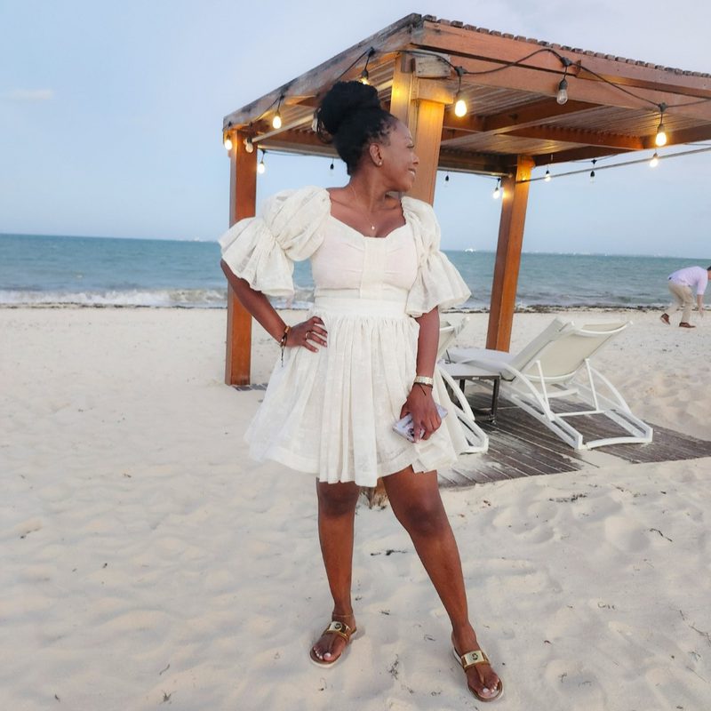 Hayley Molefe in a white dress on a beach in Cancun