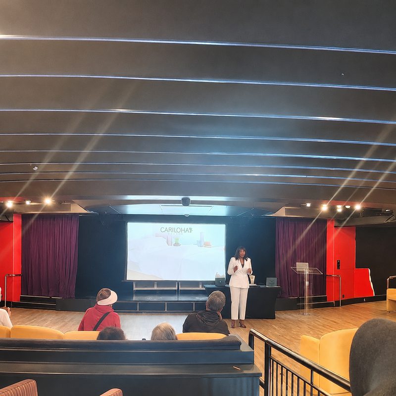 Hayley Molefe presenting a seminar in a cruise ship theatre